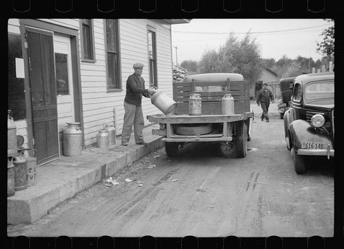 Unloading milk cans - , at
