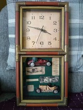 wall mounted grandfather clock with vintage car design, wood and brass frame 