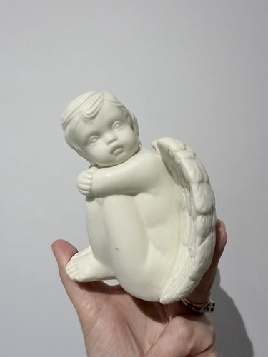 White cherub figurine is - white, it