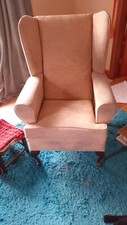 Vintage Wing Backed Fireside Chair with shaped wooden legs.
