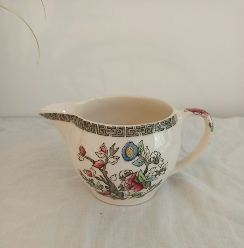 Milk jug the style of - jug.,