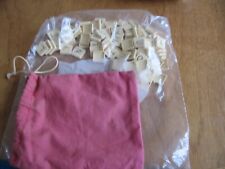 A COMPLETE SET OF SCRABBLE TILES IN BAG SQUARE BACKS