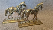 Two identical vintage brass horse figurines.