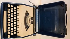 Vintage Remington Envoy III blue & white portable typewriter, manual