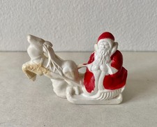 Vintage Christmas celluloid miniature of Santa and reindeer with a bell/rattle