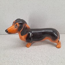 Dachshund dog figurine black tan sausage dog, Leg was repaired