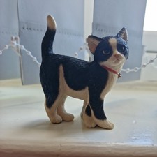 Sherratt & Simpson black and white Cat Figurine rubbing a log