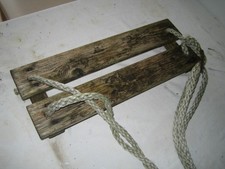 Old vintage outdoor childrens playtime rope swing