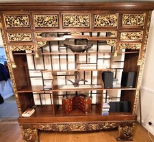 An antique Indonesian wall unit, with elaborate carved detailing.