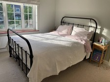 feather and black bed frame