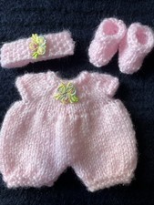 Hand knitted dolls clothes to