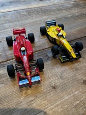 Two Scalextric 1970s style Formual 1 racing cars.