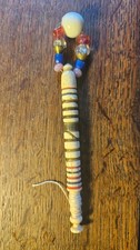 A heavy antique Victorian bone lace bobbin with spangle, wound with brass wire