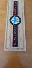 A Wooden Bar Runner/ Wall Plaque with a Newcastle Brown Ale  rubber Insert