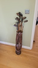 Antique vintage hickory shafted golf clubs.  Four woods, 5 irons and a putter.