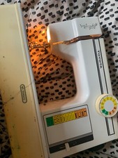 White toyota sewing machine with needles spare oil and instruction manuals  