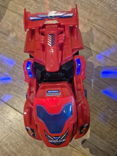 Red transforming dinosaur that - dinosaur,