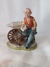 Porcelain Figurine Of An Old Man Working With Tools
