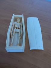 Scrimshaw style skeleton in coffin