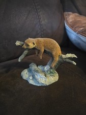 sleeping meerkat figurine from