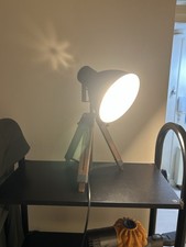 grey adjustable lamp on tripod