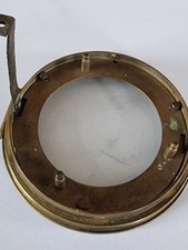 Antique brass clock bezel with bevelled glass.