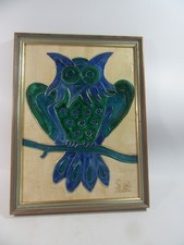A brightly coloured relief painting of an owl By SOL .