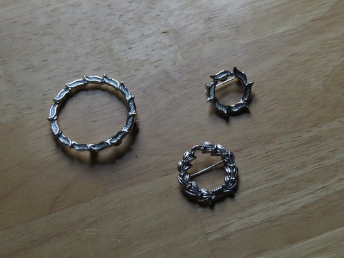 Annular silver brooches