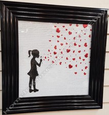 Banksy girl blowing red heart