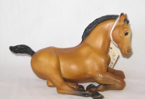 Breyer buckskin lying down