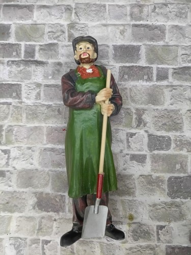 Workman with shovel suit a - with, to
