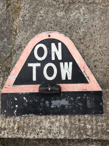 Tow metal sign old - on,