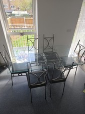 Stunning Silver Iron legs and Glass Table Top 6-seater dining table and  chairs