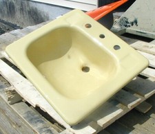 Yellow bathroom sink, cast