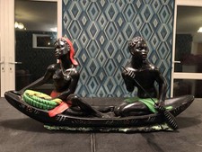 LARGE MID CENTURY CHALKWARE PLASTER FIGURE OF TWO AFRICAN PEOPLE IN A BOAT. MCM