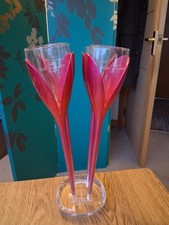 A Set Of Four Moet & Chandon Pink Tulip Champagne Flutes On Acrylic Base