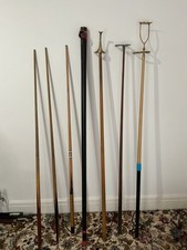 Assorted used snooker cues, rests and case.