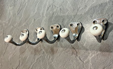 Set of five stylish chrome clothes hooks - with white ceramic end caps