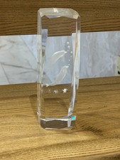 crystal glass paperweight with a laser-engraved dolphin design