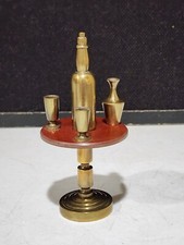 UNUSUAL VINTAGE BRASS AND BROWN BAKELITE MINIATURE TABLE WITH GOBLET VASE BOTTLE