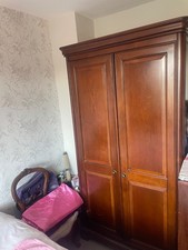 antique teak wardrobe with mirror on interior of door shelf on the other door 
