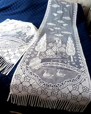 A PAIR OF VINTAGE FRENCH FRINGED PICTORAL LACE NET CURTAINS