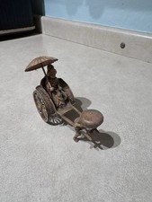vintage Japanese celluloid figurine of a geisha in a rickshaw