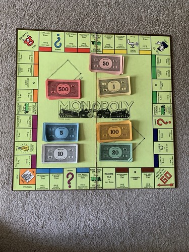 Monopoly board and money - and,