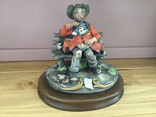 Figurine tramp sitting on - sitting,