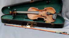 Antique violin in an ebonised