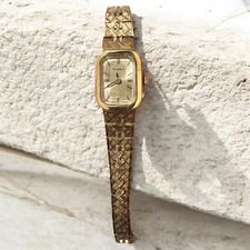 Women's Timex watch. Small Gold face with bracelet style band. 
