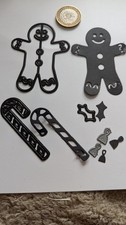 A Selection Of Christmas Theme Dies. Gingerbread Man, Candy Cane, Holly & Bells