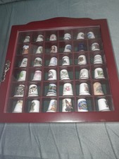 private collection of 36 exquisitely decorated thimbles in a wooden cabinet