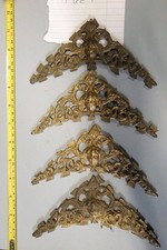 A SET OF FOUR LARGE LONGCASE/GRANDFATHER CLOCK CHERUB HEAD SPANDRELS (TYPE F)